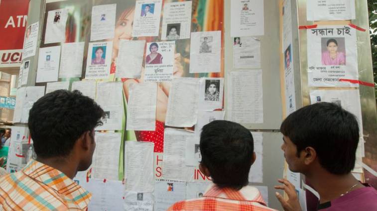 Relatives of missing RMG workers paste leaflets in walls in search of their dear ones.